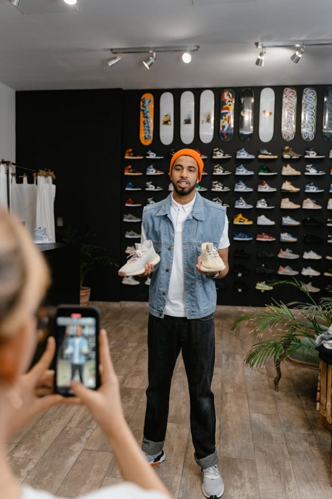 Mastering the First Impression: Your intriguing post title goes here A man demonstrates shoes for an online promotional video in a boutique shop setting.